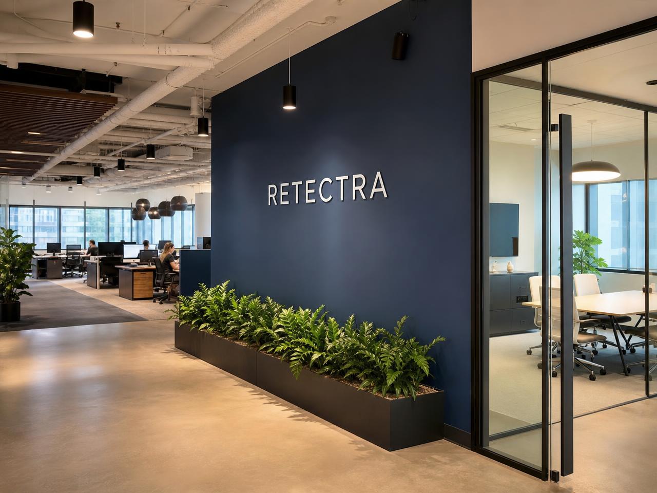 ReTectra open-plan office floor with branded navy wall and glass meeting rooms