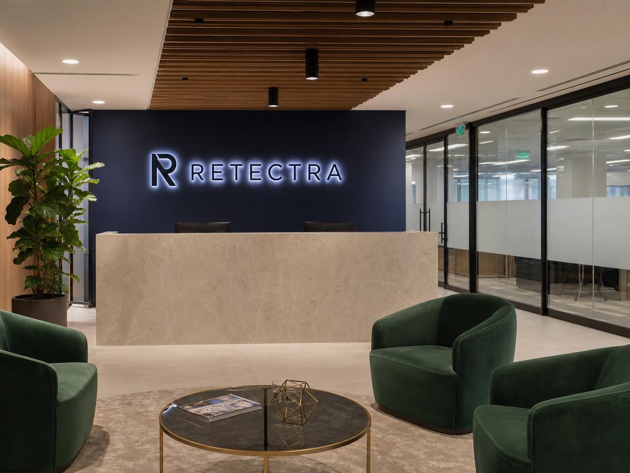 ReTectra reception lounge with illuminated brand signage and green seating